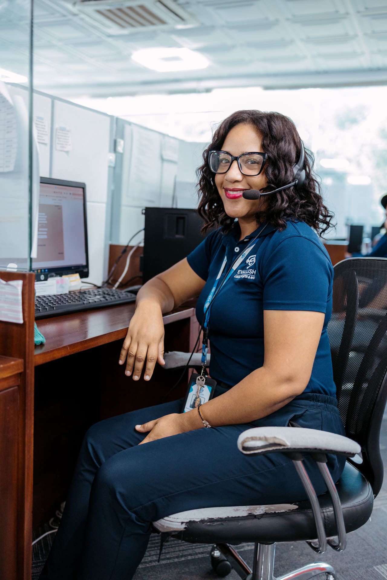 Agent working at her desk with a headset